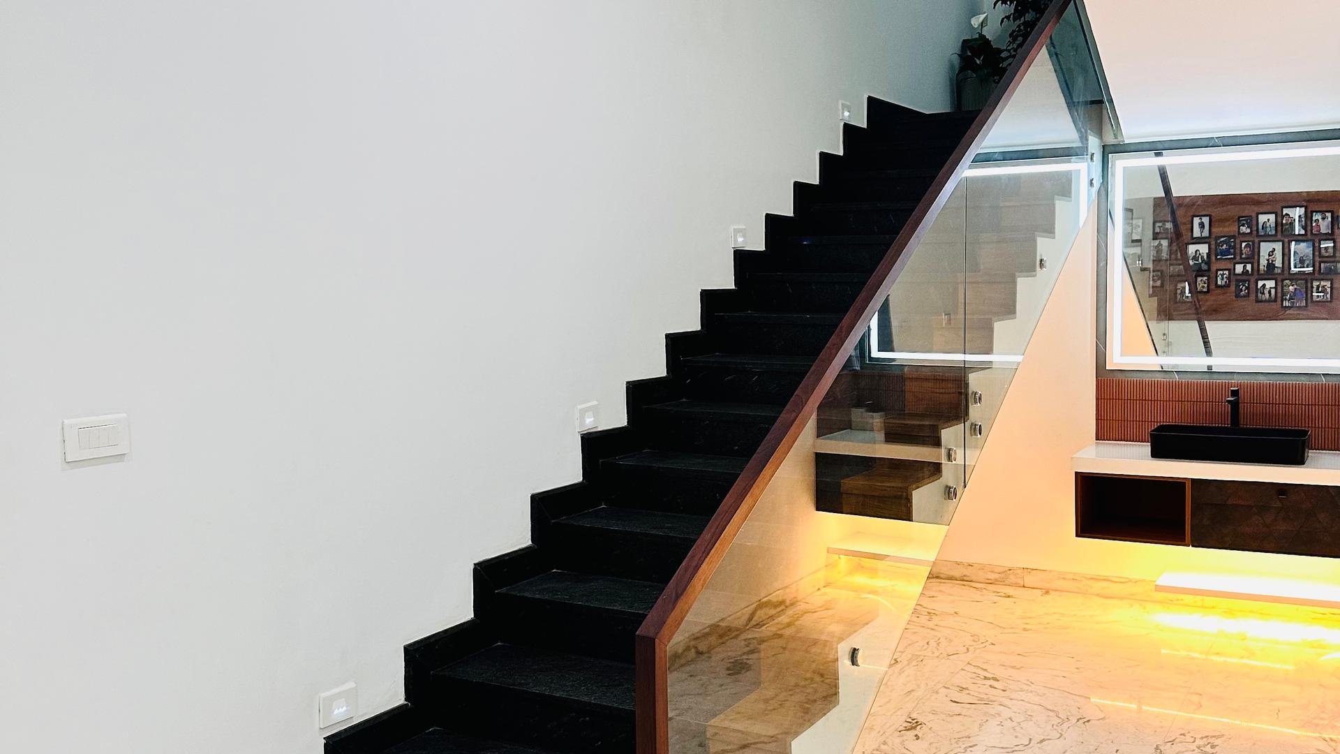 The staircase of a Cocoon-managed home in Kochi, seen from the hall.